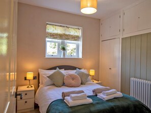 A neatly arranged bedroom with a bed, bedside tables, a window with a view, and a wardrobe. - 3 Bed in Bakewell (oc-90384) (Bakewell)