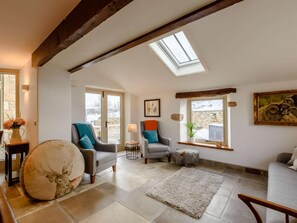 A spacious living area with a high ceiling, skylight, and large windows offering views of the outdoors. - 5 Bed in Lancaster (oc-90546) (Bentham)