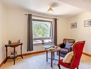 A room with a window, a table with books and a chessboard, a chair, and a lamp. - 2 Bed in Kidderminster (oc-90642) (Stottesdon)