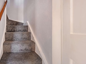 A staircase with carpeted steps and a wooden handrail. - 1 Bed in Keswick (oc-90646) (Keswick)