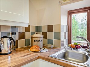 A kitchen with a bread container, a bread loaf, a butter container, a kettle, and a fruit bowl. - 2 Bed in Lincoln (oc-91059) (Ashby de la Launde)