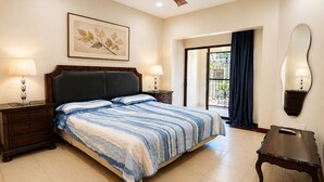 A hotel room with a bed, two bedside tables with lamps, a ceiling fan, a large window with a view, and a wall-mounted mirror. - Apto nuevo - Comunidad segura cerca de SJO y SJ (Heredia)