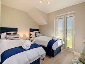 A hotel room with two beds, a balcony, and a view of the outdoors. - 2 Bed in Shaftesbury (oc-91172) (Motcombe)