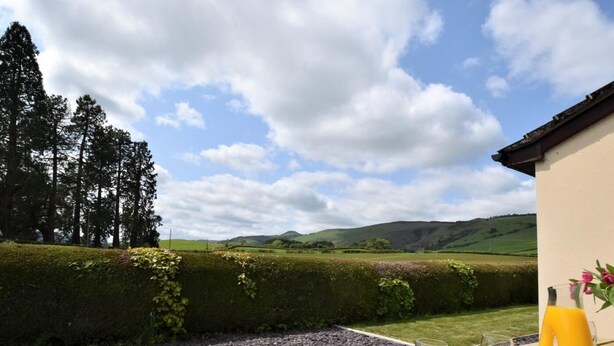 A picnic table with binoculars, a map, and a glass of juice. - 3 Bed in Presteigne (oc-90768) (Kinnerton)