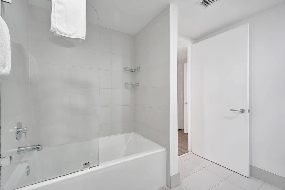 Master bathroom with complimentary toiletries and a tub
