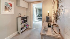 A hallway with a bookshelf, a mirror, and a door leading to another room. - 2 Bed in Consett (oc-90576) (Shotley Low Quarter)