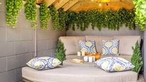 A cozy seating area with a cushioned bench, patterned cushions, and a small wooden table. - 2 Bed in Consett (oc-90576) (Shotley Low Quarter)