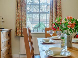 A dining table set with plates, glasses, and a vase of flowers. - 3 Bed in Richmond (oc-90578) (Catterick)