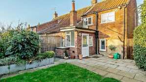 A two-story brick house with a tiled roof, a small garden, and a visible chimney. - 2 Bed in Great Walsingham (oc-90535) (Little Walsingham)
