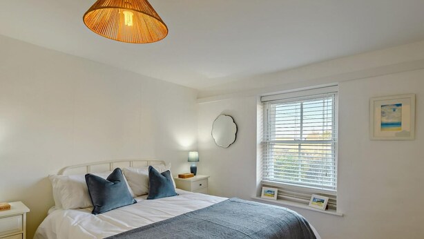 A bedroom with a bed, bedside table, lamp, window, and wall art. - 2 Bed in Great Walsingham (oc-90535) (Little Walsingham)