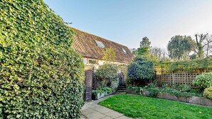 A residential property with a well-maintained garden, a paved pathway, and a wooden fence. - 2 Bed in Great Walsingham (oc-90535) (Little Walsingham)