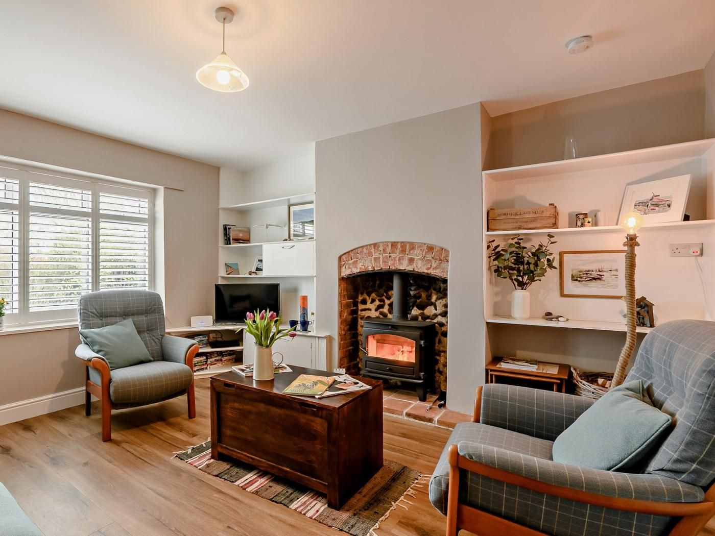 A cozy living room with a fireplace, comfortable seating, and a television.