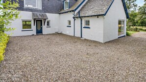 A house with a gravel driveway, a front door, and a chimney. - 5 Bed in Dunkeld (oc-90585) (Dunkeld)
