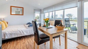 A bedroom with a bed, a desk with a chair, a window, and a view of the outdoors. - 1 Bed in Dalry (oc-91418) (Dalry)