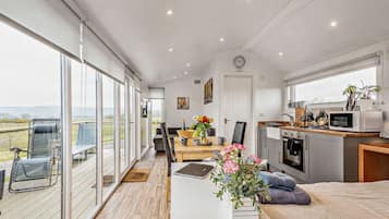 A modern kitchen with a microwave, stove, and sink.