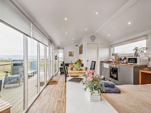 A modern kitchen with a microwave, stove, and sink.