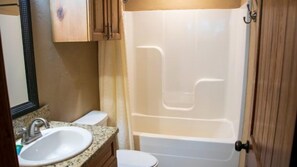 A bathroom with a sink, toilet, and bathtub.
