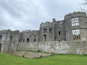 A historic stone castle with multiple towers, arched windows, and a fortified wall. - 3 Bed in Cosheston (oc-90731) (Cosheston)