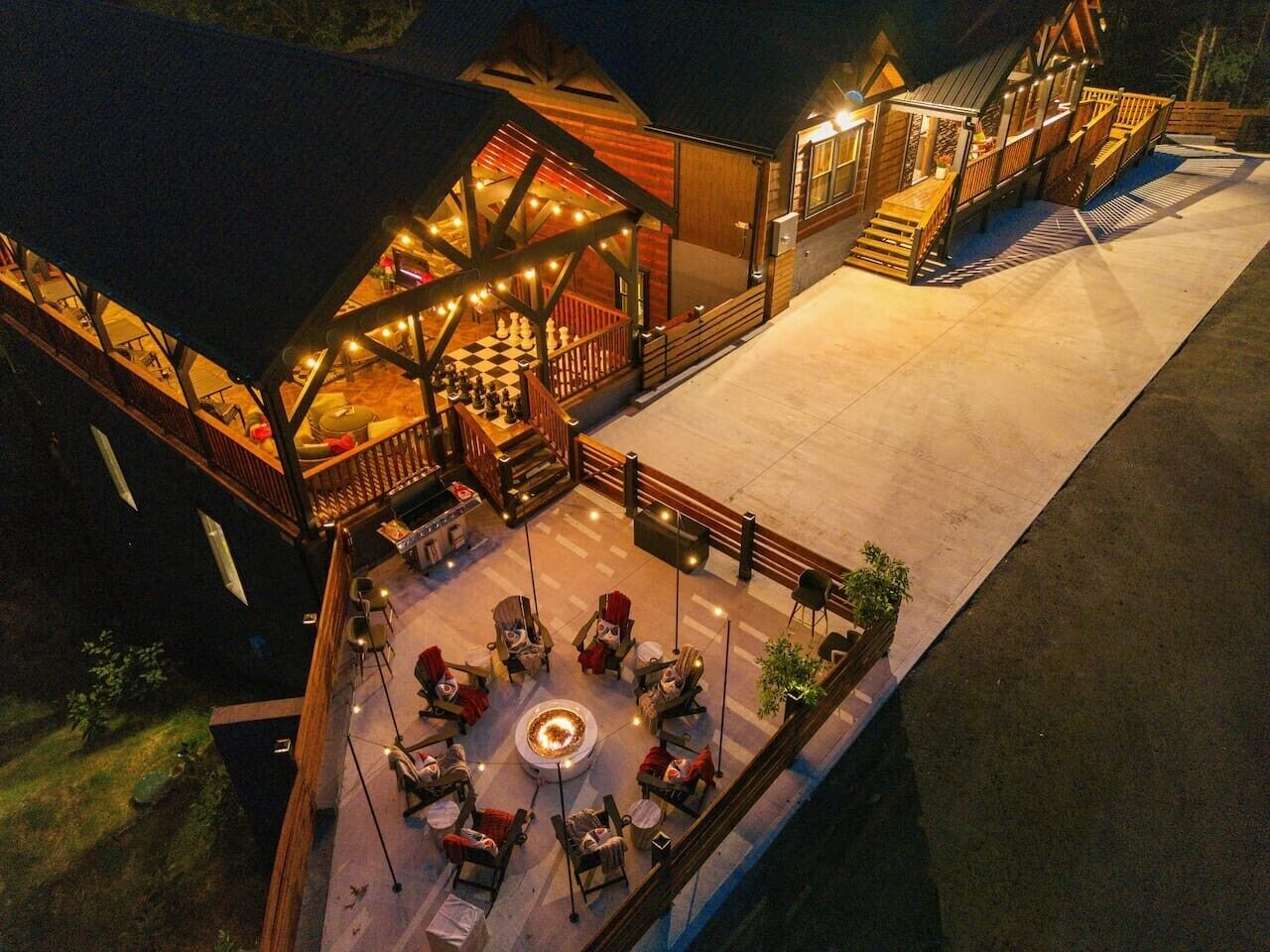 Eine Holzhütte mit einer Terrasse, Sitzgelegenheiten im Freien und einer Feuerstelle.