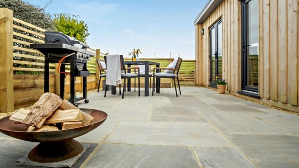 An outdoor patio with a grill, seating area, and a fire pit. - 1 Bed in Ventnor (oc-91536) (Godshill)