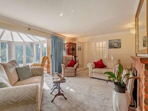 A living room with a sofa, armchairs, a coffee table, and a fireplace. - 1 Bed in Lymington (oc-92403) (Pilley)