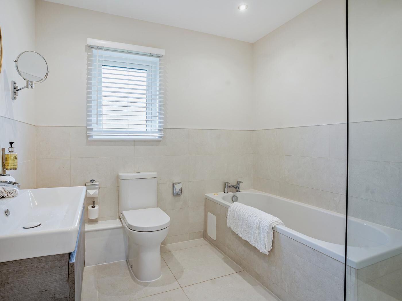 A bathroom with a toilet, sink, and bathtub.
