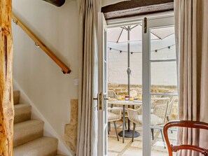 A staircase leading to a dining area with outdoor seating, a table, and chairs. - 1 Bed in Stamford (oc-92406) (Ketton)