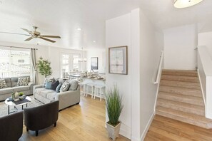 A spacious living area with a sofa, coffee table, and a staircase. - Heated Pool, PickleBall - New & Beautiful - Save Today (Washington)