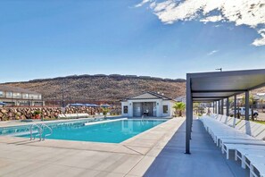 A swimming pool with lounge chairs, a small building, and a mountain in the background. - Heated Pool, PickleBall - New & Beautiful - Save Today (Washington)