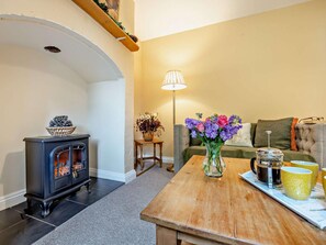 A cozy living room with a fireplace, a sofa, a coffee table with a tray of mugs, and a lamp. - 2 Bed in Alford (oc-92252) (Rigsby)