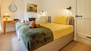 A bedroom with a bed, bedside tables, a desk, a chair, a lamp, a painting, and a door. - 2 Bed in Alford (oc-92252) (Rigsby)