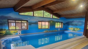 An indoor swimming pool with a mural of a landscape, windows, and a wooden ceiling. - 2 Bed in Ambleside (oc-92240) (Grasmere)
