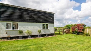 A modern two-story house with a sloped roof, a brick exterior, and a well-maintained lawn. - 1 Bed in Norwich (oc-92295) (Strumpshaw)