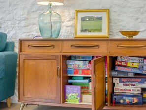 A wooden cabinet with drawers, a vase, and a framed picture on top. - 2 Bed in Buxton (oc-91974) (Wormhill)