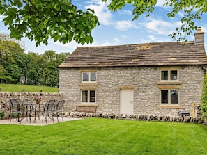 A stone house with a tiled roof, a front door, and a small porch with chairs. - 3 Bed in Buxton (oc-92127) (Tunstead)