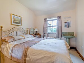 A bedroom with a bed, a window with curtains, a bedside table with a lamp, and a mirror. - 3 Bed in Pickering (oc-92356) (Cropton)