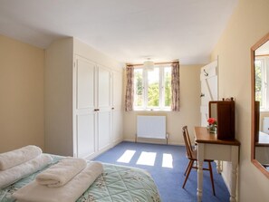 A bedroom with a bed, a desk, a chair, a radiator, and a window with curtains. - 3 Bed in Dorchester (oc-92343) (Higher Wraxall)