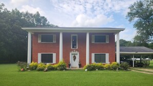 A two-story brick building with a central entrance, a covered porch, and a well-maintained lawn. - The Madison
2 story colonial style home built in 1978, with my father's own hand (Crossett)