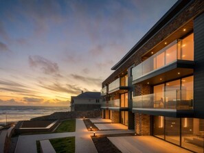 A modern building with large windows, a stone facade, and a pathway leading to the entrance. - 2 Bed in Bude (oc-92484) (Bude)