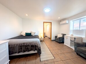 Bright, spacious bedroom with AC, cozy seating, and a clean modern look - Downtown District - Modern Apt Yard, King Bed, W/D (Albuquerque)