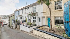 A narrow street with traditional buildings, a palm tree, and a blue door. - 3 Bed in Fowey (oc-92548) (Fowey)