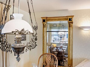 A dining area with a chandelier, a mirror, and a dining table with chairs. - 2 Bed in Keswick (oc-92600) (Keswick)