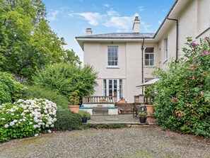 A two-story house with a front porch, a small garden, and a gravel driveway. - 4 Bed in Ludlow (oc-92835) (Cleedownton)