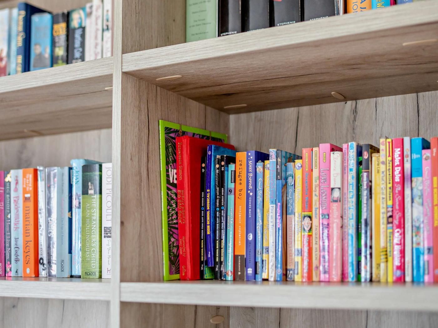 A bookshelf with a variety of books.