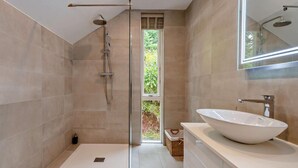 A modern bathroom with a large window, a walk-in shower, and a white sink. - 1 Bed in Paignton (oc-93061) (Marldon)
