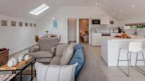 A modern apartment with a living room, dining area, kitchenette, and a bedroom. - 1 Bed in Paignton (oc-93061) (Marldon)