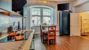 A modern kitchen with a dining area, a large window, and a television. - 2 Bed in Ambleside (oc-93167) (Hawkshead)