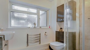 A bathroom with a toilet, sink, towel rack, and a glass shower enclosure. - 3 Bed in Burnham-on-sea (oc-92964) (Brean)