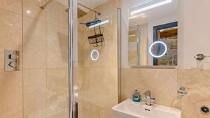 A modern bathroom with a glass-enclosed shower, a white sink with a mirror, and a light fixture. - 1 Bed in Chop Gate (oc-93100) (Chop Gate)