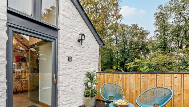 A modern building with a white exterior and a glass door entrance. - 1 Bed in Lockerbie (oc-93110) (Lockerbie)